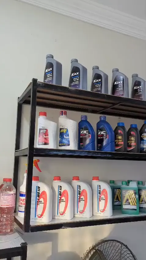 Shelves stocked with engine oils, coolants and other fluids